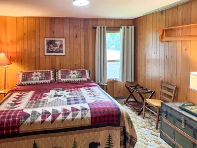 Bedroom #1 with King-Size Bed, Internet Connected Smart TV, Clothes Hanging Closet, Duo Suit Case Stands, Dresser w/Multi-Function Light Settings & Smart Device Outlets, Duo Night Stands w/Smart Device Outlets, & Black-Out Window Shades