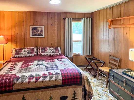 Bedroom #1 with King-Size Bed, Internet Connected Smart TV, Clothes Hanging Closet, Duo Suit Case Stands, Dresser w/Multi-Function Light Settings & Smart Device Outlets, Duo Night Stands w/Smart Device Outlets, & Black-Out Window Shades