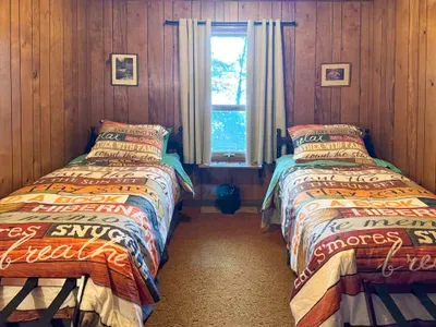 Bedroom #5 with 2 (two) twin Beds, Clothes Hanging Closet, Suit Case Stands for 2 Guests, Dresser w/Multi-Function Light / Day Time, Night-Light Settings & Smart Device Outlets, Shared Bed-Side Shelf Between Beds, & Black-Out Window Shades