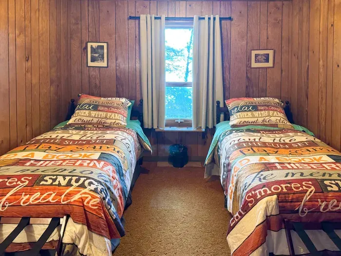 Bedroom #5 with 2 (two) twin Beds, Clothes Hanging Closet, Suit Case Stands for 2 Guests, Dresser w/Multi-Function Light / Day Time, Night-Light Settings & Smart Device Outlets, Shared Bed-Side Shelf Between Beds, & Black-Out Window Shades