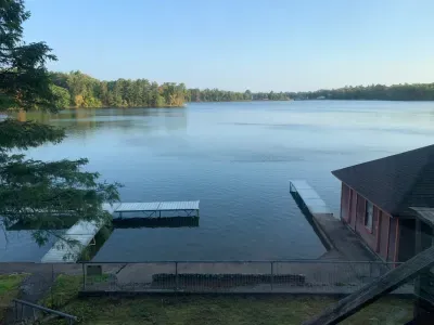 View from 5RK Lodge deck off kitchen dining area, looking north across Little Round Lake to HWY B bridge over entrance to Big Round Lake ... you can see The Dock restaurant and Round Lake Marina.  There is room for guests to dock 3-4 boats.