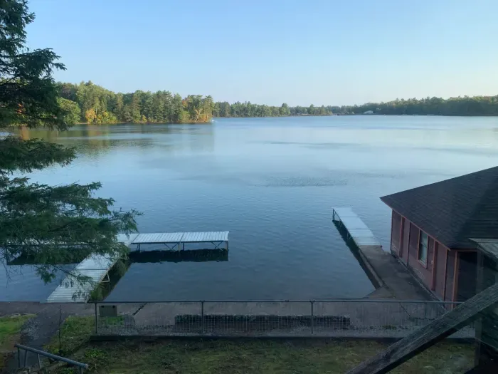 View from 5RK Lodge deck off kitchen dining area, looking north across Little Round Lake to HWY B bridge over entrance to Big Round Lake ... you can see The Dock restaurant and Round Lake Marina.  There is room for guests to dock 3-4 boats.    