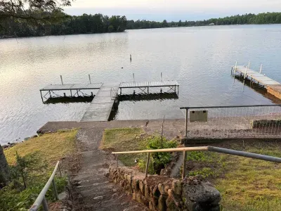 View of private boat docks (able to support 3-4 boats depending on size) and private swimming area along 500+ feet of sandy beach and lakeshore.  The boat docs form a protective shallow swim area great for young kids.
