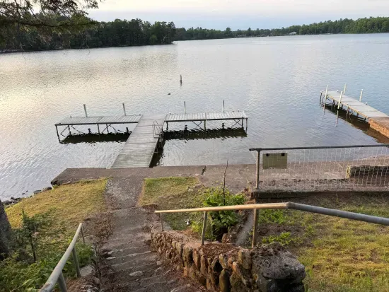 View of private boat docks (able to support 3-4 boats depending on size) and private swimming area along 500+ feet of sandy beach and lakeshore.  The boat docs form a protective shallow swim area great for young kids.