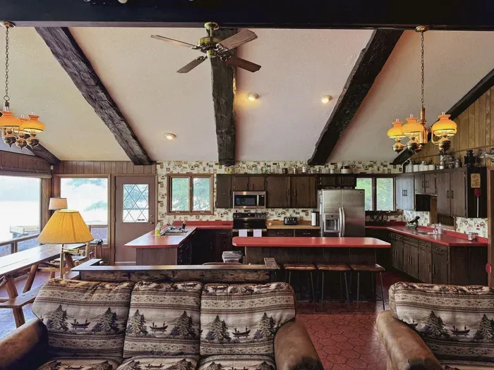 View from the living room and entertainment area fire place looking across across to the full kitchen and dining area