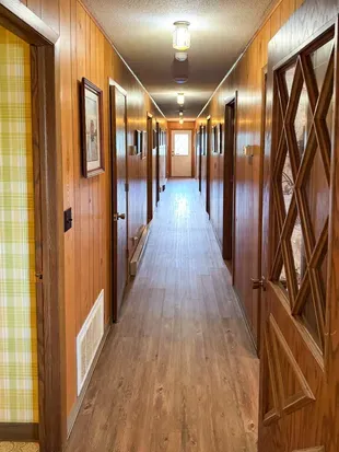 5RK Ranch Lodge bedroom annex hallway provides access to 6 bedrooms, 2 full family size bathrooms, and a private office / workspace.  The Lodge is supported by a duo-zone private and secure high-speed internet network.