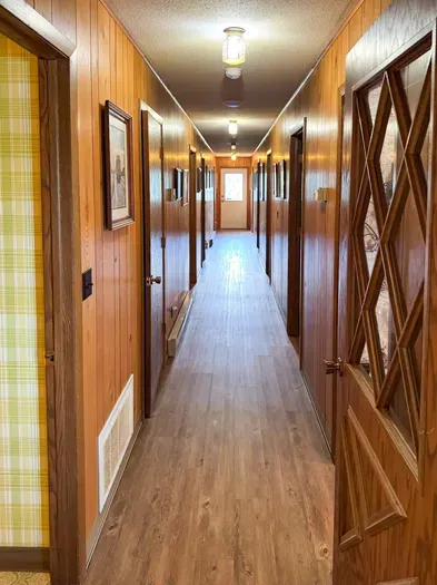 5RK Ranch Lodge bedroom annex hallway provides access to 6 bedrooms, 2 full family size bathrooms, and a private office / workspace.  The Lodge is supported by a duo-zone private and secure high-speed internet network.