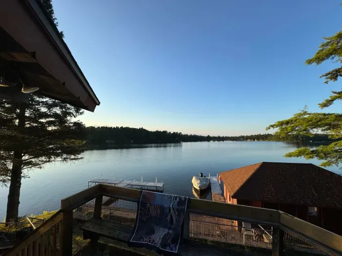 View from 5RK Lodge deck off kitchen dining area, looking north across Little Round Lake to HWY B bridge over entrance to Big Round Lake ... you can see The Dock restaurant and Round Lake Marina.  There is room for guests to dock 3-4 boats.    