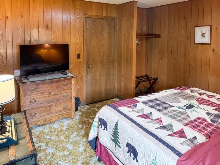 Bedroom #1 with King-Size Bed, Internet Connected Smart TV, Clothes Hanging Closet, Duo Suit Case Stands, Dresser w/Multi-Function Light Settings & Smart Device Outlets, Duo Night Stands w/Smart Device Outlets, & Black-Out Window Shades