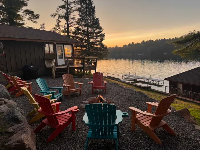 Expansive gravel fire pit and BBQ area just a couple steps down from the elevated deck overlooking the lake.  Guests are provided with 10 Adirondack chairs for use ... and plenty of room for additional chairs that guests may bring to use.  