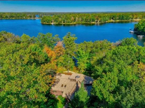 Aerial view of the Peninsula Lakehouse on 5RK Ranch Lakeside with expansive panoramic of a portion of Round Lake.