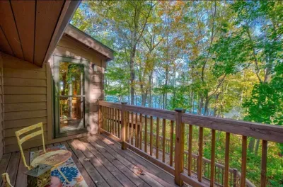 Private lakeside viewing deck off the master bedroom suite within the Peninsula Lakehouse.