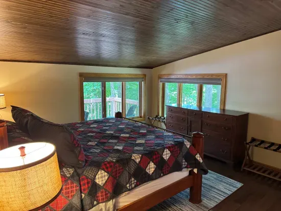Master bedroom suite and private lake view balcony.  Master bedroom suite is setup with King Bed and connected to dual vanity master bathroom with sky-lights, cedar closet, and walk in tile rain shower.