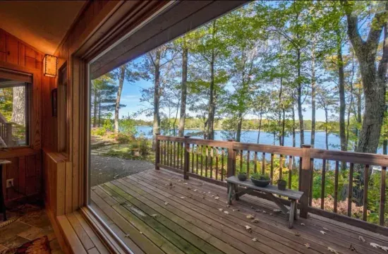 View from inside the house / sitting at the dining table situated in the parlor room, sitting area located off to the side of the kitchen and adjacent to the expansive lakeside deck.