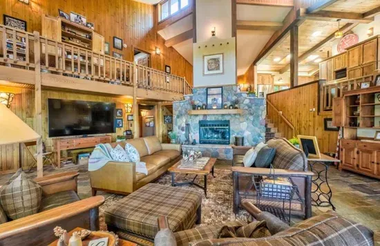 A view of the main level great room / hearth room living area within the Peninsula Lakehouse.