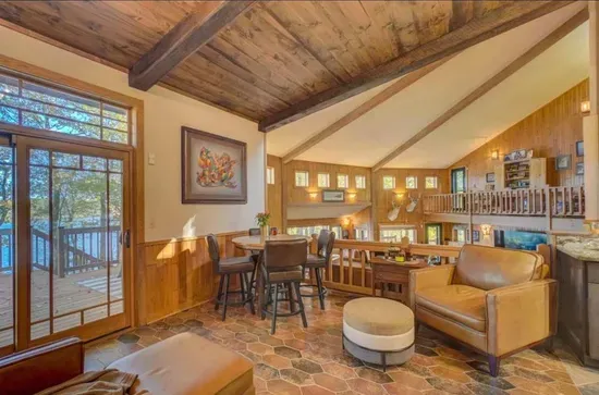 The parlor room, sitting area located off to the side of the kitchen and adjacent to the expansive lakeside deck.