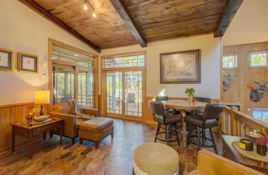 The parlor room, sitting area located off to the side of the kitchen and adjacent to the expansive lakeside deck.