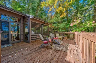Huge lakeside deck off the back of the Peninsula Lakehouse.  The screened in porch is visible to the right side.
