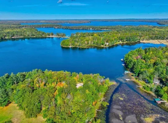 Aerial view of the Peninsula Lakehouse on 5RK Ranch Lakeside with expansive panoramic of a portion of Round Lake.