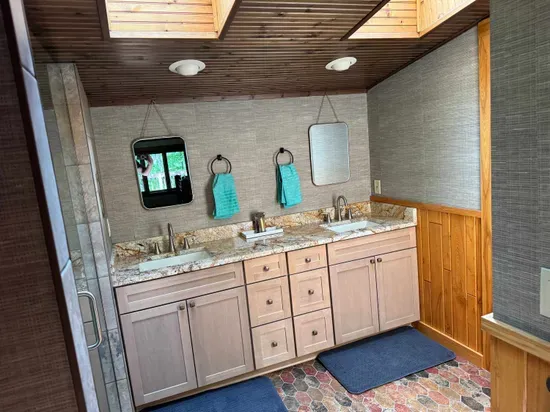 Master bedroom suite and private lake view balcony.  Master bedroom suite is setup with King Bed and connected to dual vanity master bathroom with sky-lights, cedar closet, and walk in tile rain shower.