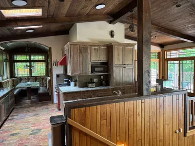 View of gourmet eat-in kitchen from front entry foyer of the Peninsula Lakehouse.  This is a bi-level open floor plan with continuous views of the lake and follows the contour of the lots' peninsula shoreline.