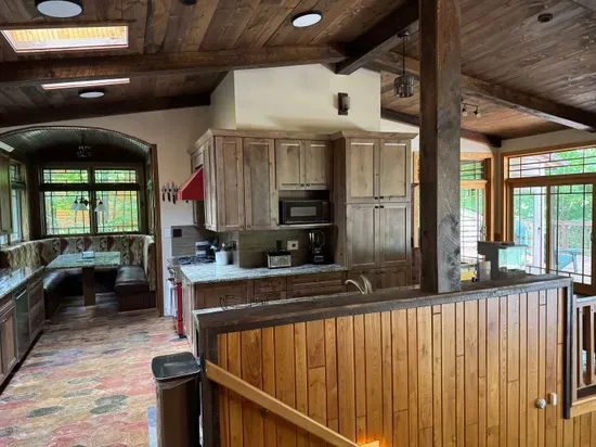 View of gourmet eat-in kitchen from front entry foyer of the Peninsula Lakehouse.  This is a bi-level open floor plan with continuous views of the lake and follows the contour of the lots' peninsula shoreline.