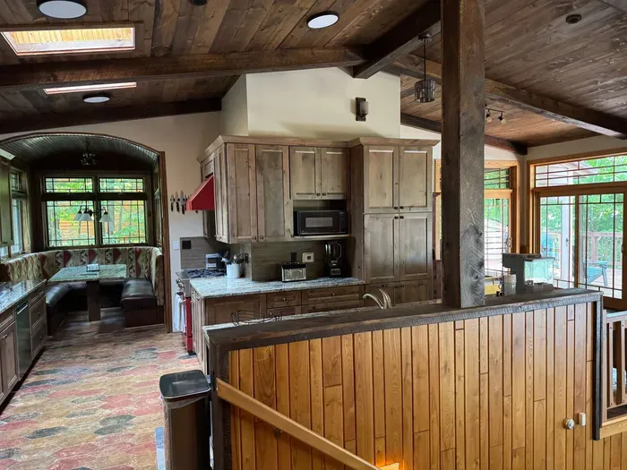 View of gourmet eat-in kitchen from front entry foyer of the Peninsula Lakehouse.  This is a bi-level open floor plan with continuous views of the lake and follows the contour of the lots' peninsula shoreline.