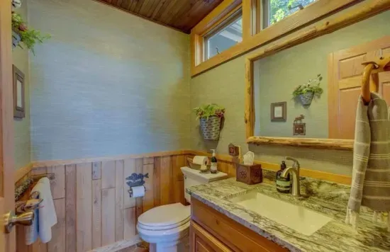 Renovated half-bathroom off the kitchen & parlor room / sitting area, adjacent to the expansive lakeside deck.
