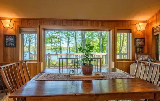 One of the dining tables situated in the parlor room, sitting area located off to the side of the kitchen and adjacent to the expansive lakeside deck.