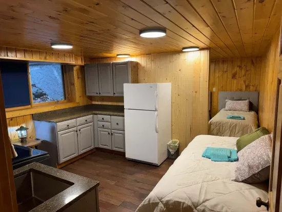 Peninsula Lake House is comprised of a finished lower level utility space that serves multiple purposes; full size washer dryer / sink, 2nd refrigerator/freezer, and split-room bunk room for kids and youth with 4 twin beds.