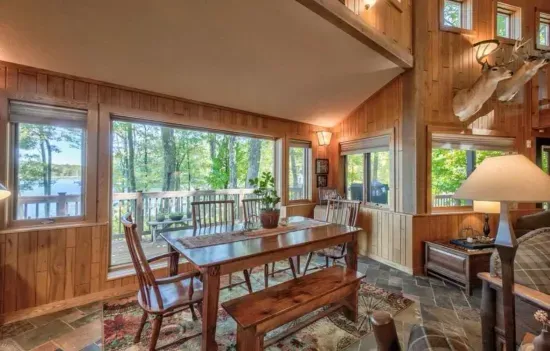 One of the dining tables situated in the parlor room, sitting area located off to the side of the kitchen and adjacent to the expansive lakeside deck.