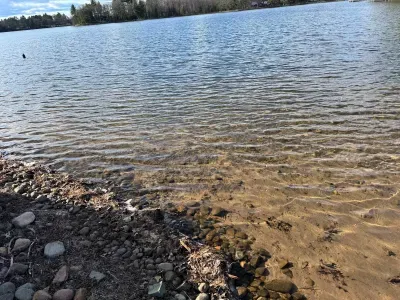 Private boat and swimming dock along shallow sandy beach on crystal clear Little Round Lake with easy boat access to the entirety of Round Lake.