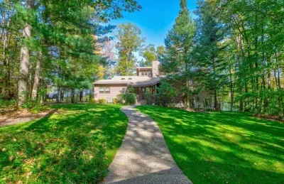 Front yard & main front entry door view of the Peninsula Lakehouse from the garage & parking area.