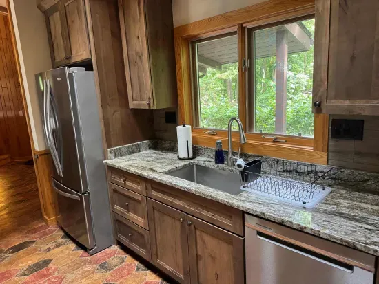 View of gourmet eat-in kitchen in the Peninsula Lakehouse.  This is a bi-level open floor plan with continuous views of the lake and follows the contour of the lots' peninsula shoreline.