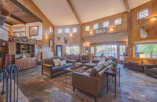 Main level great room / hearth room living area within the Peninsula Lakehouse, with lake views from every place in the room!
