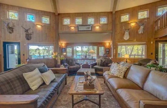 Main level great room / hearth room living area within the Peninsula Lakehouse, with lake views from every place in the room!