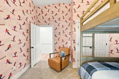 Bunk beds, ski wallpaper, and a toy boat — this room does not do boring.