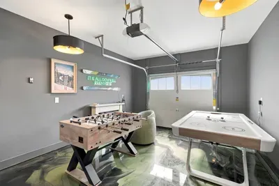 Vintage skis, neon glow, foosball on deck — this wall has main character energy