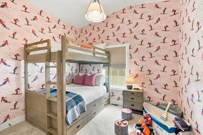 Bunk beds, ski wallpaper, and a toy boat — this room does not do boring.