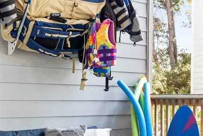 Screen porch with 2 SUPs, beach chairs, beach wagon, Cool Cabana, and beach pool toys