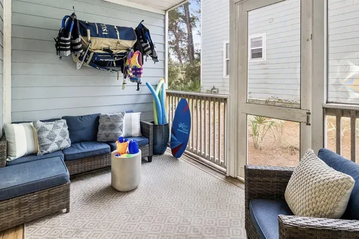 Screen porch with 2 SUPs, beach chairs, beach wagon, Cool Cabana, and beach pool toys