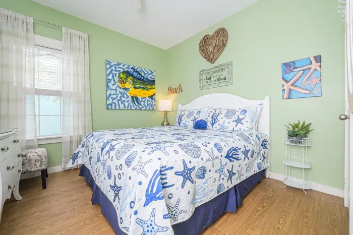 Relax in this coastal-theme bedroom featuring king size bed