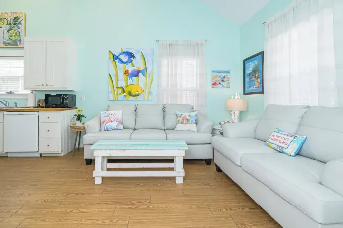 Cool leather sofa's in this coastal retreat filled with tropical inspired artwork!. !!BONUS!!! Queen Size Sofa Sleeper with comfy foam mattress.