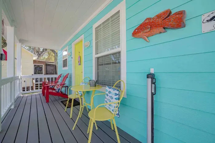 Relax on the covered front porch, complete with tables, chairs and a baby gate for the littles