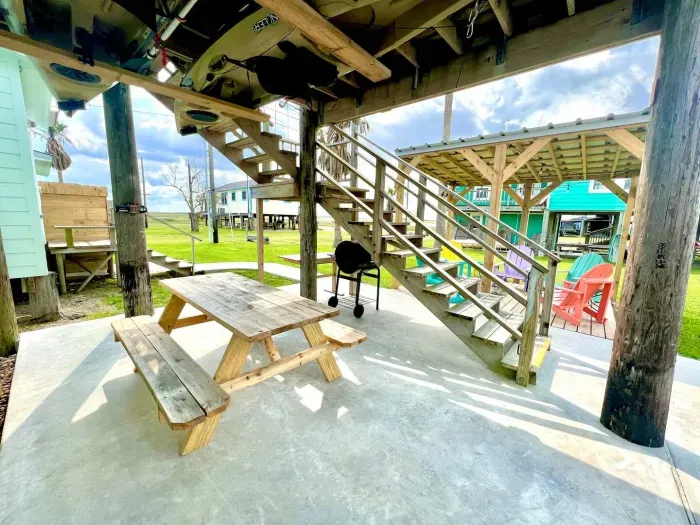 Chillin' and grillin' !  Plenty of room for telling stories on this shaded patio featuring  wooden picnic table.