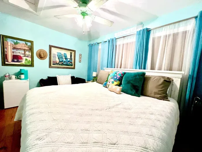 King bed with oh-so-comfortable mattress and bedding.  Cozy, vacay vibe.  Wall-mounted TV, fridge, Keurig, clothing storage and ensuite bathroom with rain-showerhead which includes hand held shower wand.  All linens provided.