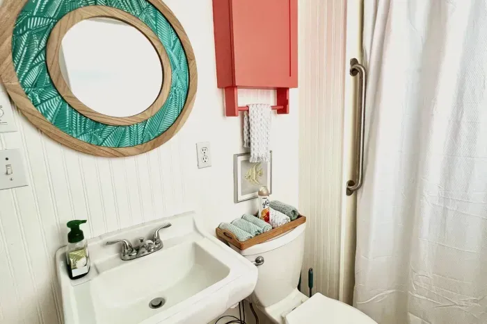 Main house downstairs bathroom,  pedestal sink, toilet and step in shower with grab bars. Towels provided