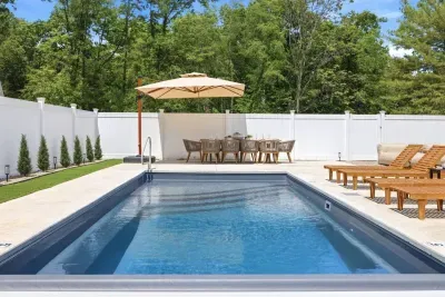 Private outdoor retreat with heated pool, fire table, outdoor dining, hot tub & space to relax, gather, & entertain.