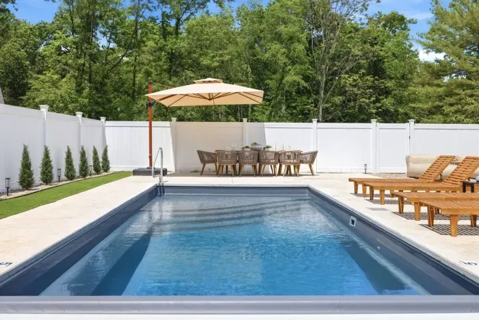 Private outdoor retreat with heated pool, fire table, outdoor dining, hot tub & space to relax, gather, & entertain.