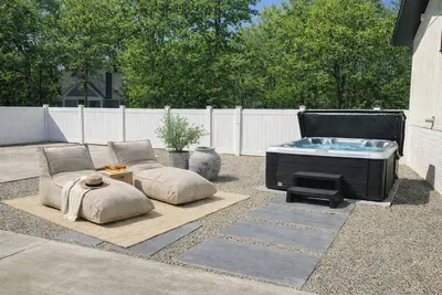 Private hot tub retreat with cozy lounge seating—perfect for relaxing after a day at the beach or exploring New Buffalo.